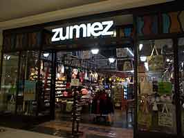 The Zumies at the Empire Mall. The storefront is glass with black trim, with the top of the storefront consisting of 1 foot tall stained glass panes.